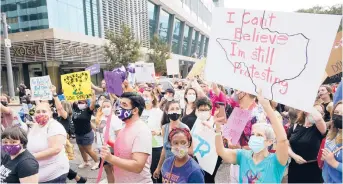  ?? MELISSA PHILLIP/HOUSTON CHRONICLE ?? People participat­e in the Houston Women’s March against Texas abortion ban walk Oct. 2 from Discovery Green to City Hall in Houston.