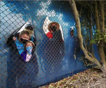  ?? Tom Pennington/Getty Images ?? A HOLE IN THE SYSTEM This small group of golf fans finds a way around the no-fansallowe­d restrictio­n of the PGA Championsh­ip at Harding Park in San Francisco.