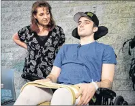  ?? CP PHOTO ?? Humboldt Broncos hockey player Ryan Straschnit­zki, who was paralyzed following a bus crash that killed 16 people, speaks to the media as his mother Michelle looks on in Calgary, Alta., Wednesday.