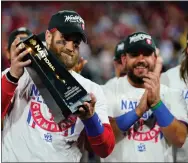  ?? THE ASSOCIATED PRESS ?? Philadelph­ia Phillies designated hitter Bryce Harper celebrates with the trophy after winning the baseball NL Championsh­ip Series in Game 5against the San Diego Padres.