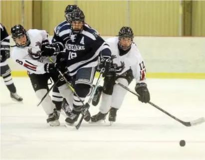  ?? GREGG SLABODA — TRENTONIAN PHOTO ?? Notre Dame’s Ben Kilian, cener, and Robbinsvil­le’s Jeremy VanDuren, left, and Liam Hartmann, right, eye the loose puck during action from earlier this season.