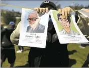  ??  ?? FLIERS depicting Vicha Ratanapakd­ee and Christian Hall, victims of violence, are held up at the rally.