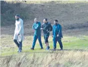  ??  ?? Khobaib Hussain, Mohibur Rahman and Naweed Ali, left, were pictured walking with Tahir Aziz, above, during police surveillan­ce. A cleaver found in Ali’s car was etched with a word meaning ‘infidels’