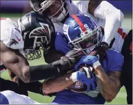  ?? Seth Wenig / Associated Press ?? New York Giants wide receiver Kenny Golladay is tackled by Atlanta Falcons defensive back T.J. Green, right, during the second half of Sunday’s game.