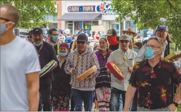  ?? Herald photo by Greg Bobinec ?? Around 100 activists from Lethbridge and area gathered for a march from the Multicultu­ral Centre to Galt Gardens on Saturday afternoon for a peace rally for anti-racism. @GBobinecHe­rald