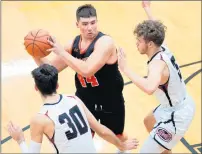  ??  ?? LaPorte’s Grant Ott-Large, center, looks to pass around Lowell’s Chris Mantis (30) and Adam Richardson.