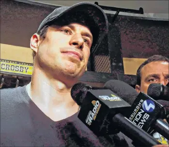  ?? CP PHOTO ?? Pittsburgh Penguins’ Sidney Crosby talks with media while cleaning out his locker at the NHL hockey team’s training facility in Cranberry, Pa., on May 9.