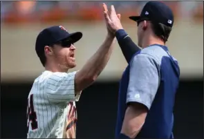  ?? The Associated Press ?? TWINS’ TREY: Minnesota Twins’ Logan Forsythe, left, celebrates the Twins’ 6-4 win Wednesday over the Pittsburgh Pirates in Minneapoli­s. Forsythe, a recent addition to the team, had three RBIs.