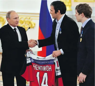  ?? YURI KADOBNOV / THE CANADIAN PRESS / FILES ?? Russian President Vladimir Putin, left, can count on the support of many of Russia’s top sports stars, including NHL forward Alex Ovechkin, centre, in this weekend’s presidenti­al election.