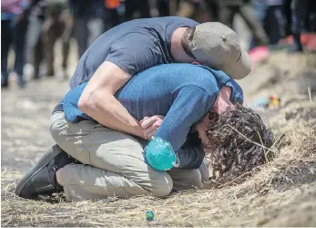  ?? MULUGETA AYENE / THE ASSOCIATED PRESS ?? Relatives react at the scene where the Ethiopian Airlines Boeing 737 Max 8 crashed shortly after takeoff on Sunday killing all 157 on board, near Bishoftu, south of Addis Ababa, in Ethiopia.