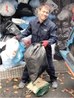  ??  ?? Former world flyweight champion Malcolm Tuñacao goes about his day job as a garbage collector in Kobe, Japan. (Photo courtesy of Malcolm Tuñacao)