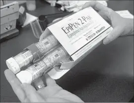  ?? Rich Pedroncell­i Associated Press ?? FDA APPROVAL of the generic comes near the start of the school year, when EpiPen sales spike as parents stock up, sometimes leading to shortages.