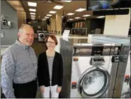  ?? DAN SOKIL — DIGITAL FIRST MEDIA ?? WashStop Laundry Center owners Barrett and Janet Van Dame stand next to new washing machines in their recently reopened laundromat on Friday, April 6 2018.