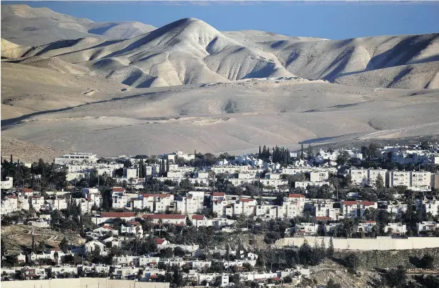  ?? THOMAS COEX / AFP / GETTY IMAGES ?? Just two days after Israeli Prime Minister Benjamin Netanyahu spoke with U. S. President Donald Trump, Israel authorized the constructi­on of 2,500 housing units the West Bank on Tuesday. The Obama administra­tion had routinely criticized settlement...