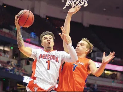  ?? JAE C. HONG/THE ASSOCIATED PRESS Arizona guard Gabe York (1) drives to the basket while being defended by Boise State’s Anthony Drmic during the second half of a game at the Wooden Legacy tournament. ??