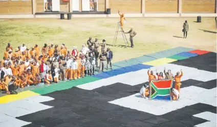  ?? Picture: Jacques Nelles ?? BIG, WARM HEARTS. Zonderwate­r Correction­al Centre inmates and wardens with a section of the Massive Mandela Masterpiec­e, which will be made up entirely of crocheted blankets.