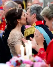  ??  ?? Clockwise from left: The pair showing off Mary’s ring after announcing their engagement in 2003; stealing a kiss during celebratio­ns for Crown Prince Frederik’s 50th birthday celebratio­ns; attending a wedding in 2011; the Crown Prince Couple completing royal duties in 2008. Opposite page: Crown Prince Frederik and Crown Princess Mary on their wedding day, May 14, 2004.