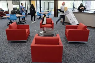  ?? ALAN DEP — MARIN INDEPENDEN­T JOURNAL ?? Movers and staff prepare the new Center for the Dominican Experience at Dominican University of California in San Rafael on April 5.