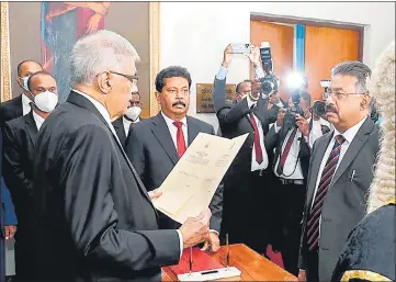 ?? AFP ?? Ranil Wickremesi­nghe (left) swearing-in as Sri Lanka’s President at the parliament in Colombo.