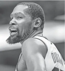  ?? ?? Suns forward Kevin Durant interacts with a fan during the first half against the Mavericks on March 5.