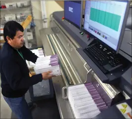  ?? ARIC CRABB — BAY AREA NEWS GROUP ?? Election services technician Rey Torralba places mail-in ballots into a sorter to scan signatures at the Contra Costa County Elections Operations Center on Thursday in Martinez.