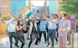  ?? HT PHOTOS ?? People watching Neeraj Chopra’s performanc­e on a TV at his native village Khandra in Panipat district on Saturday, and (right) staff members of Lovely Profession­al University celebratin­g the incredible feat of their student at the Tokyo Olympics.