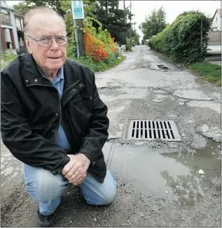  ??  ?? TYLER BROWNBRIDG­E/The Windsor Star Coun. Hilary Payne is photograph­ed in an alley off Erie Street. Payne is concerned about the cost
to fix aging alleyways and says the city should step up efforts to sell them off.