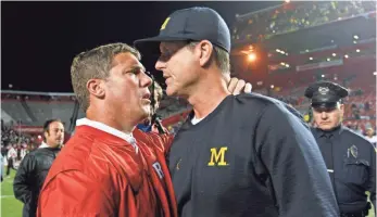  ?? MEL EVANS AP ?? Rutgers’ Chris Ash, left, greets Michigan’s Jim Harbaugh after the Wolverines’ 78-0 win Oct. 8.