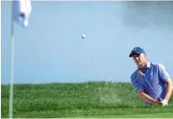  ?? AP ?? Jordan Spieth blasts out of a bunker on the 16th hole. —