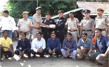  ??  ?? The seven Rohingya men sit as Indian and Myanmar security officials exchange documents before their deportatio­n on India-Myanmar border at Moreh in the northeaste­rn state of Manipur, India. — Reuters photo