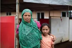  ?? (Hanna Adcock/Save the Children) ?? Vilma, 38, and her 10 year-old daughter Aisah stand outside a Save the Children temporary learning centre near Marawi