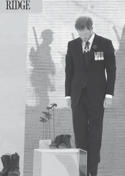  ?? ANDY COMMINS, POOL / GETTY IMAGES ?? Prince Harry contemplat­es a sculpture of poppies by artist Bernard Freseau and soldiers’ boots at the Vimy commemorat­ion on Sunday. The Vimy monument records the names of 11,285 Canadians who died in France and whose bodies were never found.