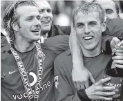  ?? Getty Images ?? David Beckham, left, and Phil Neville celebrate Manchester United’s Premiershi­p trophy in 2003.