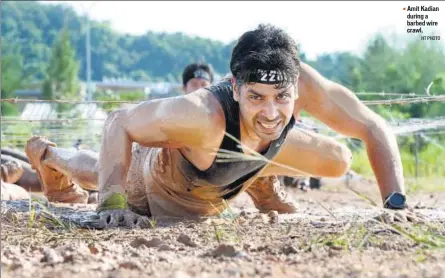  ?? HT PHOTO ?? Amit Kadian during a barbed wire crawl.