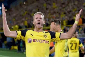  ?? — AFP ?? Dortmund midfielder André Schuerrle celebrates after scoring in their first leg match against Real Madrid at the BVB Stadium in Dortmund on Tuesday. The match ended 2- 2.