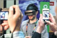  ?? AP ?? A man demonstrat­es a prototype VR headset at the Lenovo booth during CES unveiled before CES Internatio­nal in Las Vegas. The VR headset tracks head movements using cameras in the headset.