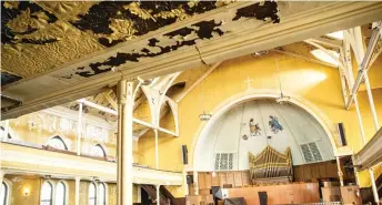  ?? PAT NABONG/SUN-TIMES ?? A mural depicting Jesus as a Black man and former church members cast as angels decorates the dome-like ceiling of the Quinn Chapel A.M.E. Church at 2401 S. Wabash Ave. Water damage is visible on walls throughout the building.