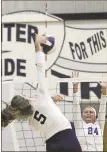  ??  ?? Gordon Lee’s Brooklyn Hudson goes up high for a shot as Ringgold’s Zoie Metcalf provides interferen­ce. Hudson and the Lady Trojans won in straight sets last Tuesday in the season opener for both teams.