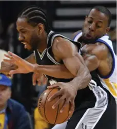  ?? THEARON W. HENDERSON/GETTY IMAGES ?? The Warriors’ Andre Iguodala defends against the Spurs’ Kawhi Leonard on Sunday during Game 1 of the NBA Western Conference finals in Oakland.