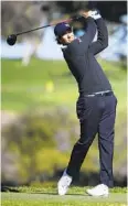  ??  ?? Adam Scott, who is two strokes off the lead heading into the final round, hits his tee shot on the fifth hole at Torrey Pines South.