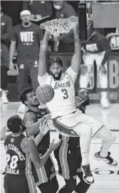  ?? MIKE EHRMANN/GETTY IMAGES ?? Anthony Davis of the Lakers dunks for two of his 19 points Sunday in Game 6 against Miami. He also grabbed 15 rebounds on the way to his first NBA championsh­ip.