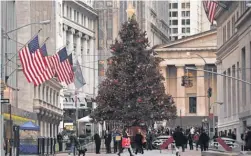  ?? STAN HONDA, AFP/GETTY IMAGES ?? Analysts say holiday cheer often leads investors to buy stocks — and it doesn’t hurt if you get a yearend bonus.