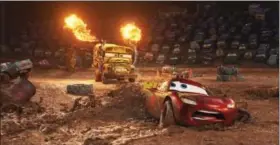  ?? DISNEY-PIXAR VIA AP ?? This image released by Disney shows Lightning McQueen, voiced by Owen Wilson, In “Cars 3,” foreground, in a scene from “Cars 3.”