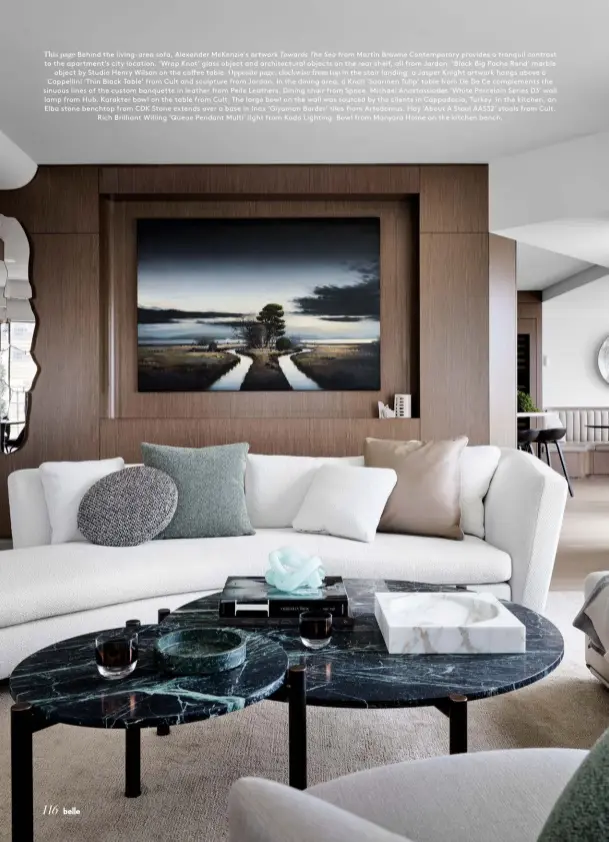  ??  ?? This page Behind the living-area sofa, Alexander McKenzie’s artwork Towards The Sea from Martin Browne Contempora­ry provides a tranquil contrast to the apartment’s city location. ‘Wrap Knot’ glass object and architectu­ral objects on the rear shelf, all from Jardan. ‘Block Big Poche Rond’ marble object by Studio Henry Wilson on the coffee table. Opposite page, clockwise from top In the stair landing, a Jasper Knight artwork hangs above a Cappellini ‘Thin Black Table’ from Cult and sculpture from Jardan. In the dining area, a Knoll ‘Saarinen Tulip’ table from De De Ce complement­s the sinuous lines of the custom banquette in leather from Pelle Leathers. Dining chair from Space. Michael Anastassia­des ‘White Porcelain Series D3’ wall lamp from Hub. Karakter bowl on the table from Cult. The large bowl on the wall was sourced by the clients in Cappadocia, Turkey. In the kitchen, an Elba stone benchtop from CDK Stone extends over a base in Inax ‘Giyaman Border’ tiles from Artedomus. Hay ‘About A Stool AAS32’ stools from Cult. Rich Brilliant Willing ‘Queue Pendant Multi’ light from Koda Lighting. Bowl from Manyara Home on the kitchen bench.