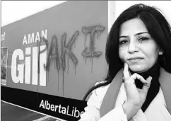  ?? BRIAN GAVRILOFF, THE JOURNAL ?? Edmonton-Mill Creek Liberal candidate Aman Gill stands by a defaced campaign sign.