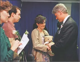  ??  ?? Aren Almon of Oklahoma City clutches a teddy bear as she is greeted April 23, 1995, by President Bill Clinton in Oklahoma City after a prayer service for the victims of the bombing in downtown Oklahoma City. Almon’s 1-year old daughter, Baylee, was killed in the attack.
(AP File/Pat Sullivan)