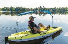  ?? ?? Mike Plante, owner of Travel Country Outfitters, shows off the Hobie Passport 10.5 at Secret Lake Park in Casselberr­y on Aug. 18.