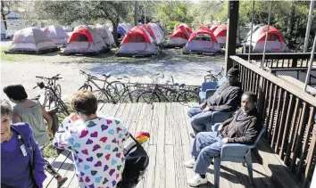  ?? DOUGLAS R. CLIFFORD Tampa Bay Times ?? Pinellas Hope residents soak up some sun on Feb. 27 in Clearwater. Residents live in 134 tents and 90 cottages.