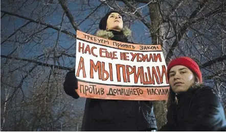  ?? — AP ?? in this filepic, a woman holds a banner reading, ‘We demand the adoption of a law against domestic violence. We have not been killed yet, but we’re close,’ at a rally in moscow. domestic violence in russia is a national problem that isn’t addressed.