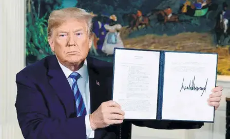  ??  ?? DONALD TRUMP after he signed the Presidenti­al Memorandum ceasing the U.S.’ participat­ion in the nuclear deal on May 8 at the White House.